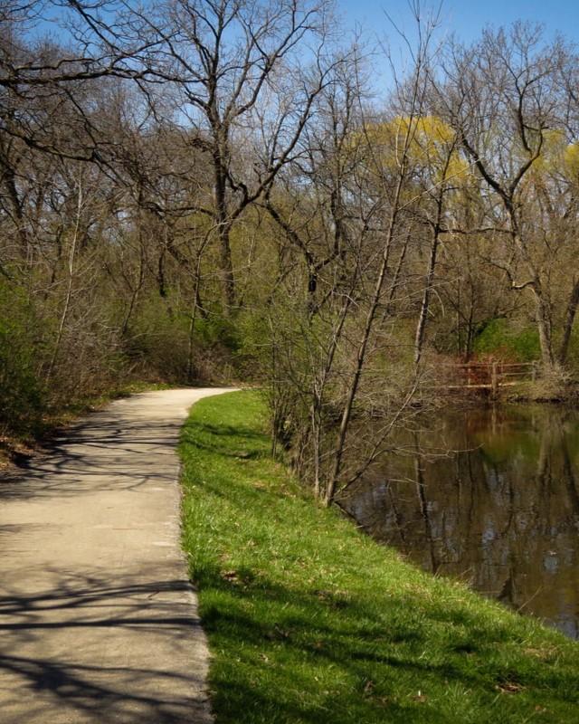 gravel trail along a pond in fall