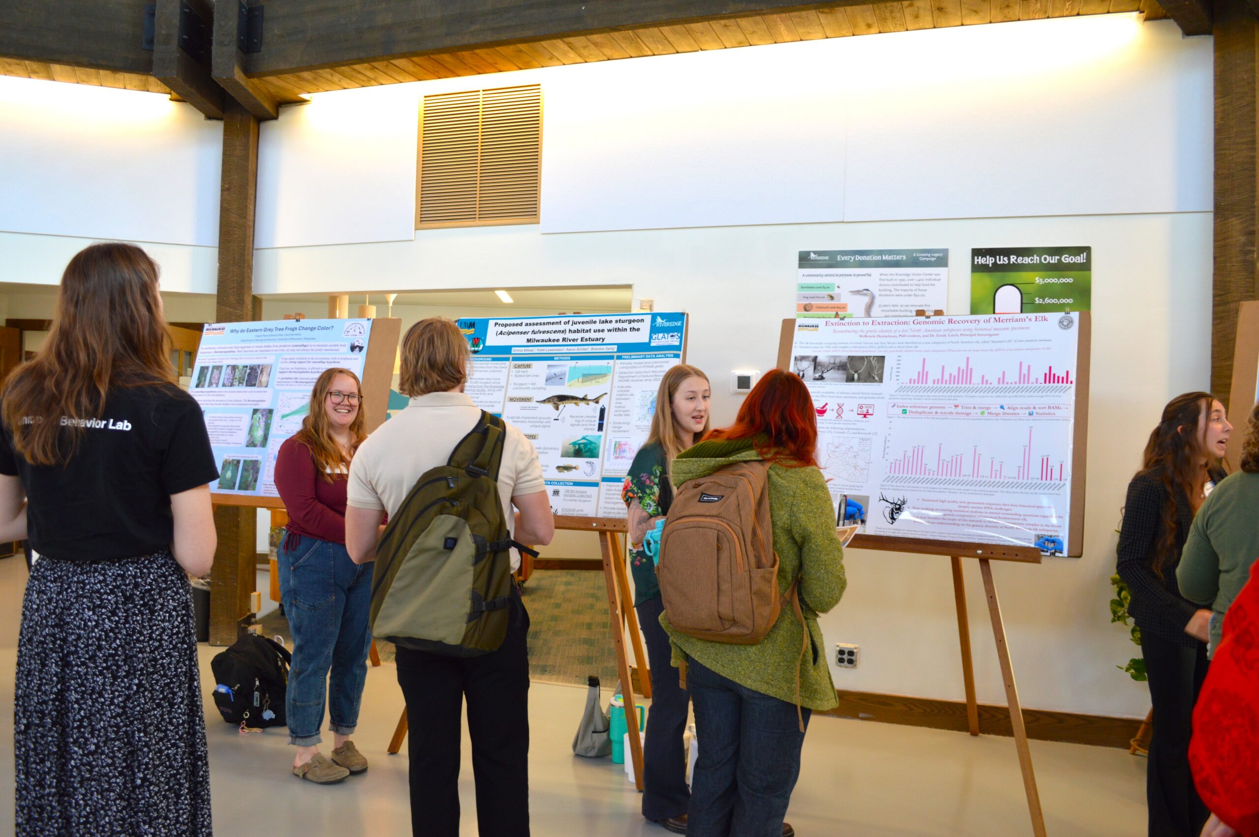 2 college students present their research posters in the Riveredge Visitor Center