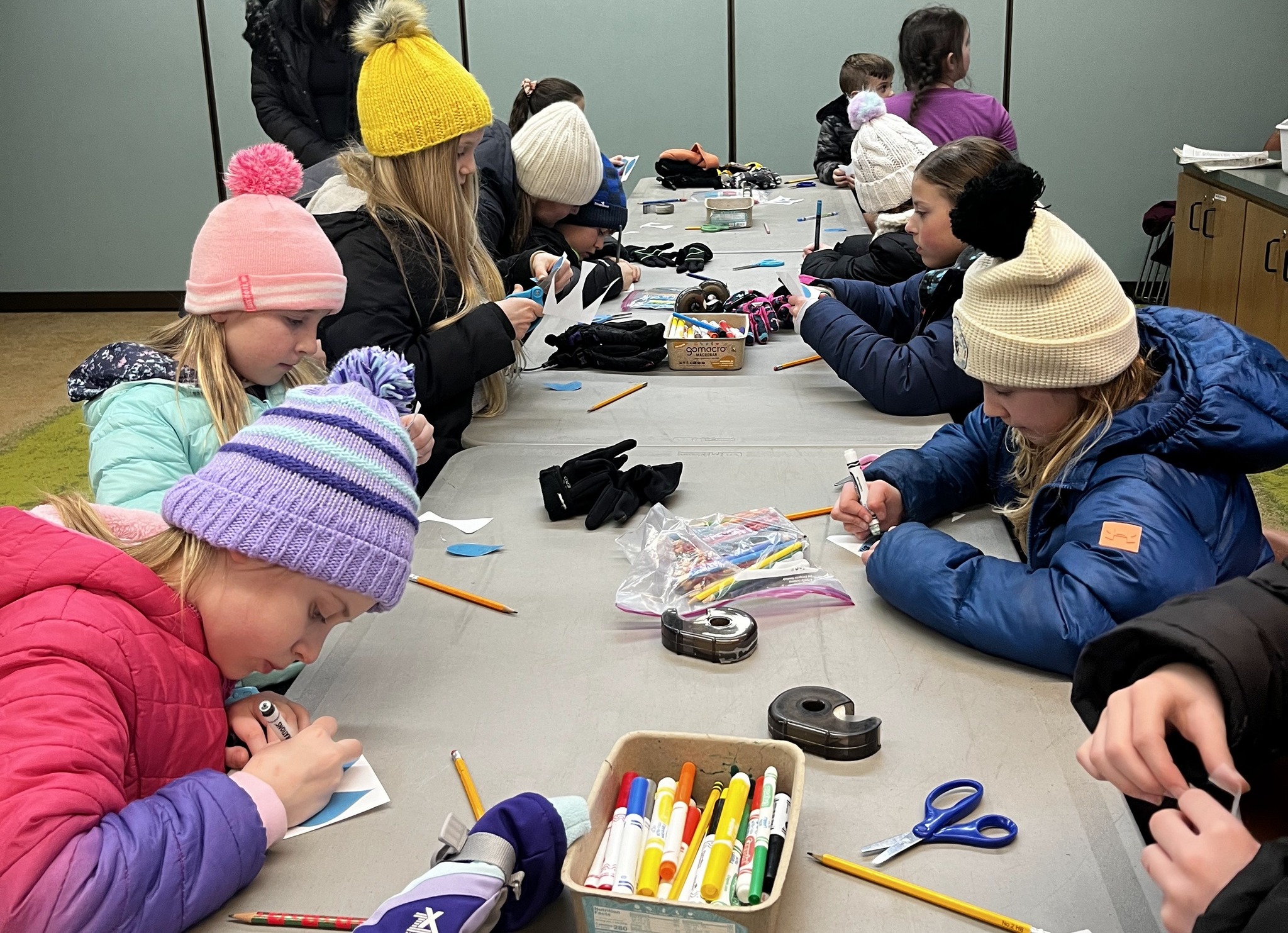 a group of students coloring together at a table